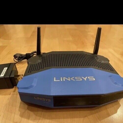 Linksys WRT1200AC 1200 Mbps 4-Port Gigabit Wireless AC Router with power cord.