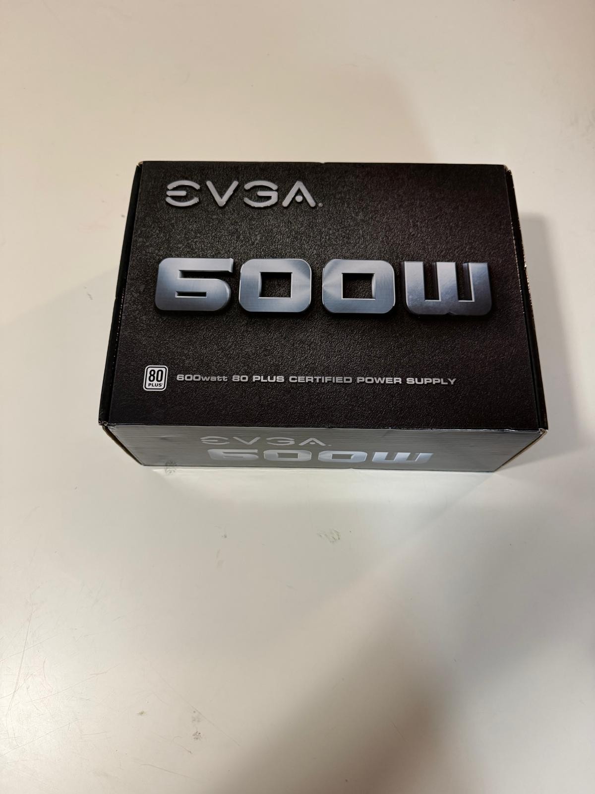EVGA 600W 80 Plus Certified ATX power supply in new, unused condition.