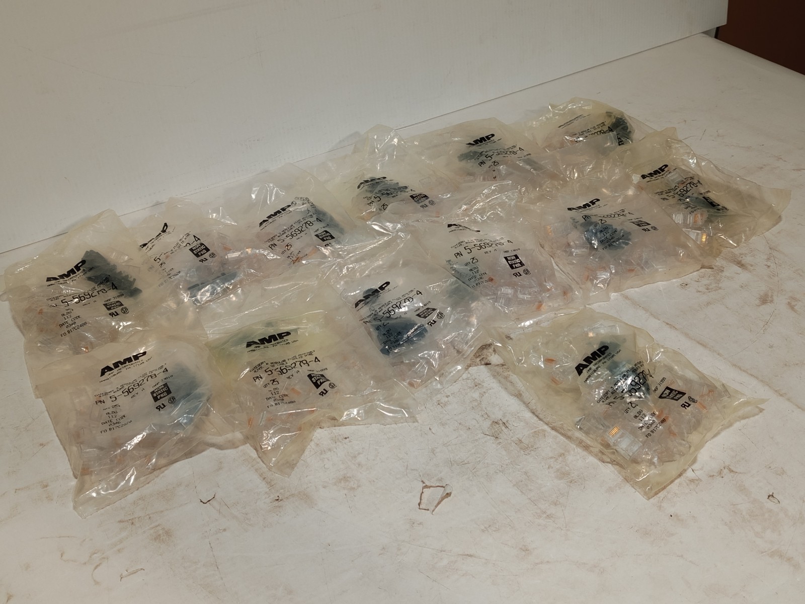 Lot of 13 bags of AMP 5-569278-4 RJ45 Cat3 modular plugs, solid wire, 25/bag