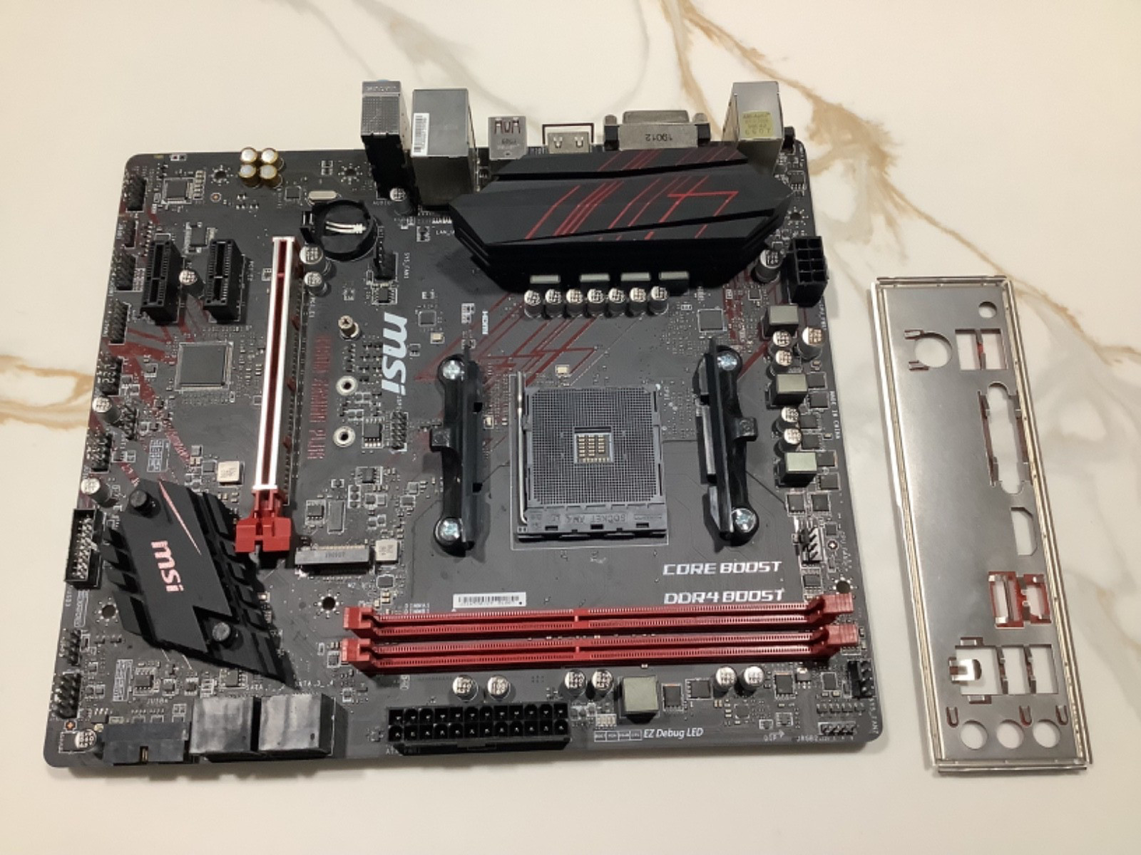 MSI B450M GAMING PLUS DDR4 MOTHERBOARD, AND BACK PLATE. NO BIOS BATTERY.