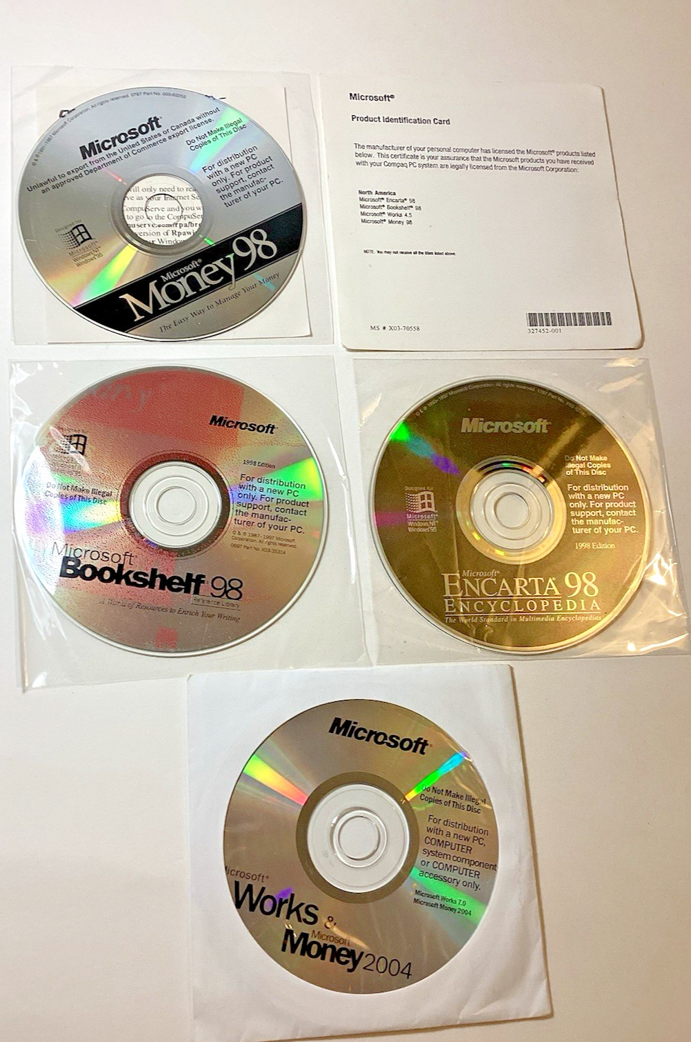 Microsoft Set of 4 Software Discs/Encarta & Bookshelf '98 + Works & Money 2004