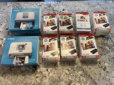 2 Canon SELPHY compact photo printers and Canon KP-108IP ink and paper sets picture